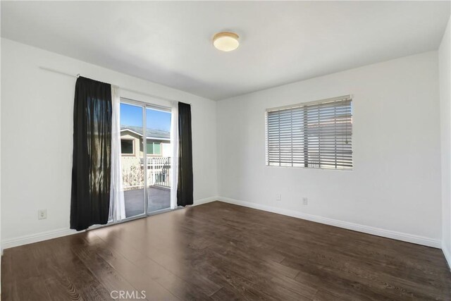 542 W Grand Ave, Pomona, CA 91766 - unfurnished room with baseboards and dark wood finished floors