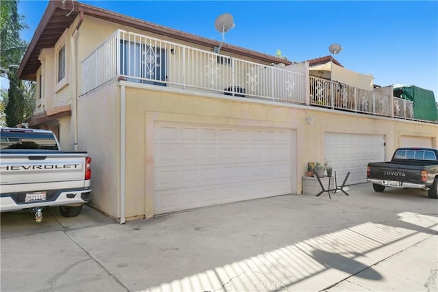 542 W Grand Ave, Pomona, CA 91766 - exterior space with concrete driveway, an attached garage, a balcony, and stucco siding