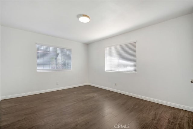 542 W Grand Ave, Pomona, CA 91766 - spare room featuring baseboards and dark wood finished floors