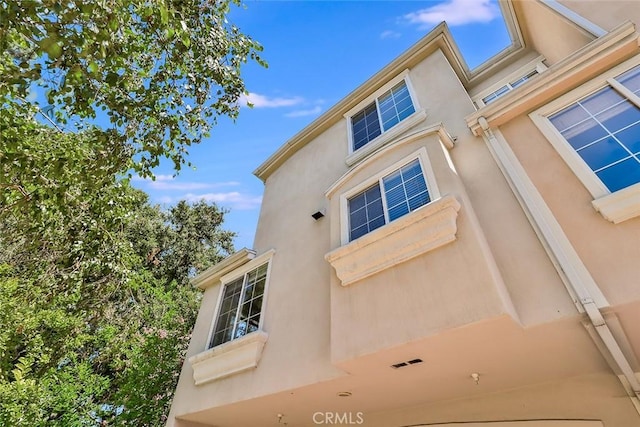 view of side of home featuring stucco siding