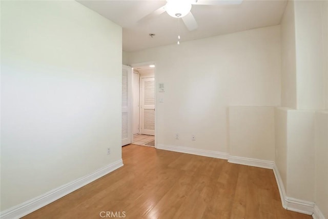 unfurnished room featuring light wood-type flooring, baseboards, and ceiling fan