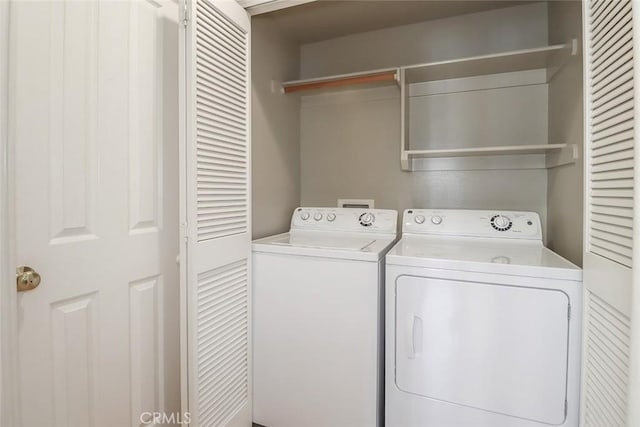 washroom featuring laundry area and washer and clothes dryer