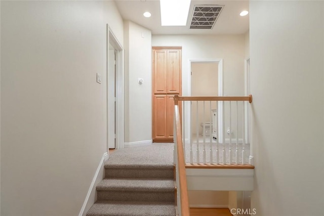 stairway featuring baseboards, recessed lighting, and visible vents