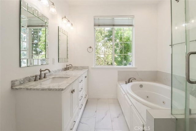 bathroom featuring a sink, marble finish floor, and a healthy amount of sunlight