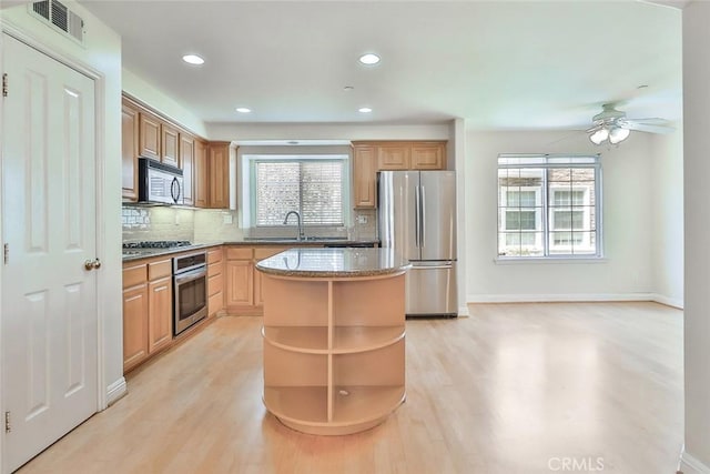 kitchen featuring open shelves, light wood finished floors, a kitchen island, and stainless steel appliances
