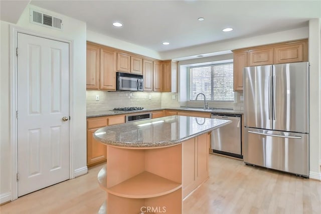 kitchen featuring visible vents, appliances with stainless steel finishes, open shelves, stone counters, and light wood-style flooring