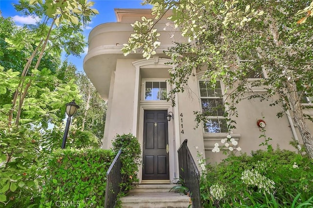 view of exterior entry featuring stucco siding