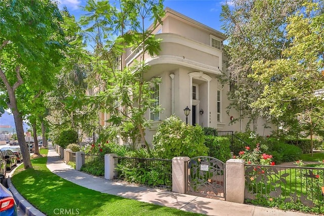 view of front of home featuring a fenced front yard and stucco siding
