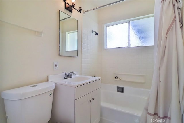 bathroom with shower / bath combo with shower curtain, toilet, and vanity