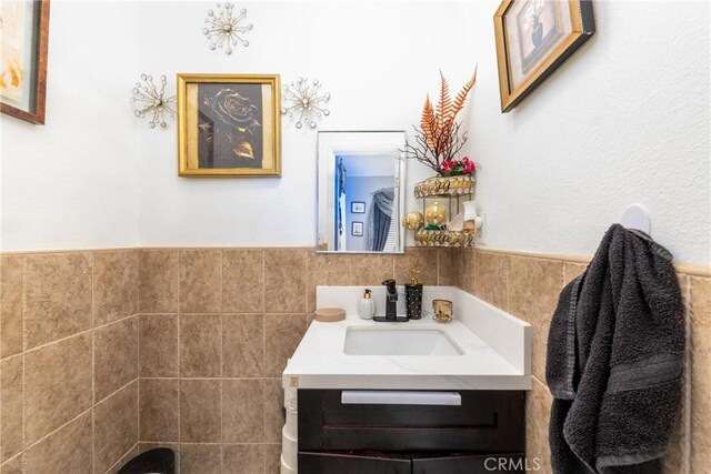 12005 Washington Blvd, Whittier, CA 90606 - bathroom featuring tile walls, vanity, and wainscoting