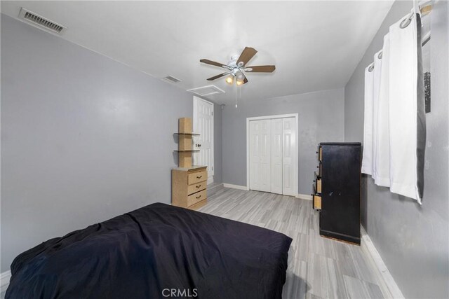 12005 Washington Blvd, Whittier, CA 90606 - bedroom with baseboards, wood finished floors, attic access, ceiling fan, and a closet