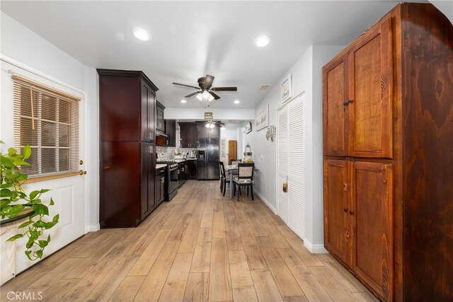 12005 Washington Blvd, Whittier, CA 90606 - kitchen featuring ceiling fan, gas range, black fridge, light wood-type flooring, and baseboards
