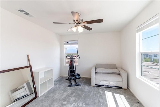 workout room with carpet floors, a ceiling fan, baseboards, and visible vents
