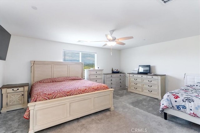 bedroom with ceiling fan and light carpet