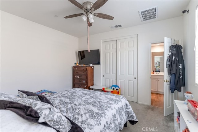 bedroom with visible vents, ceiling fan, a closet, and light colored carpet