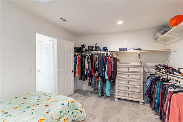 bedroom featuring visible vents and light carpet