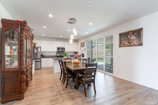 dining space with light wood-style floors, recessed lighting, and baseboards