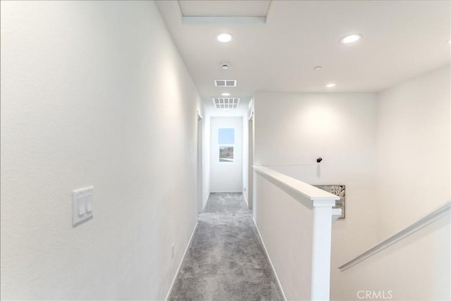 hallway with light colored carpet, recessed lighting, baseboards, and an upstairs landing