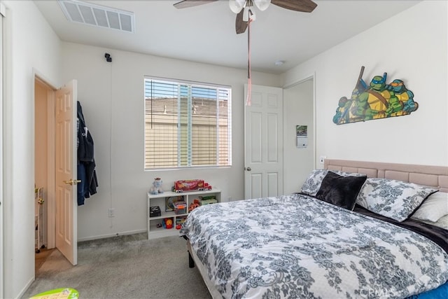 carpeted bedroom featuring visible vents, baseboards, and ceiling fan