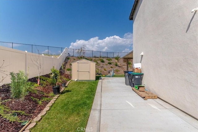 view of yard featuring a fenced backyard, an outbuilding, and a shed