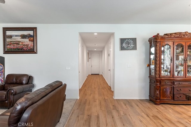 corridor with recessed lighting, baseboards, and light wood-style flooring