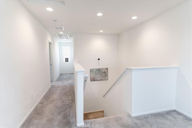 corridor with light colored carpet, an upstairs landing, recessed lighting, and visible vents