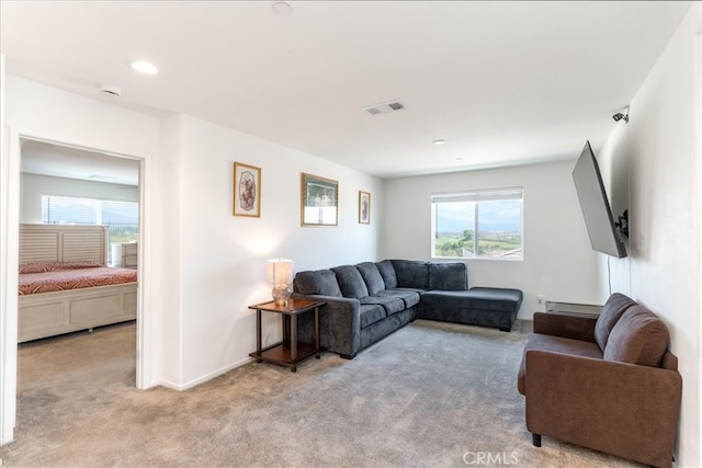 living area featuring recessed lighting, baseboards, visible vents, and carpet