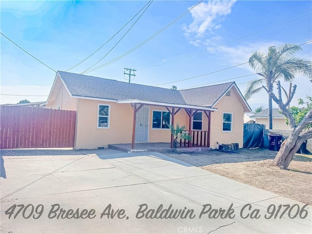 4709 Bresee Ave, Baldwin Park, CA 91706 - ranch-style house with covered porch, fence, roof with shingles, and stucco siding