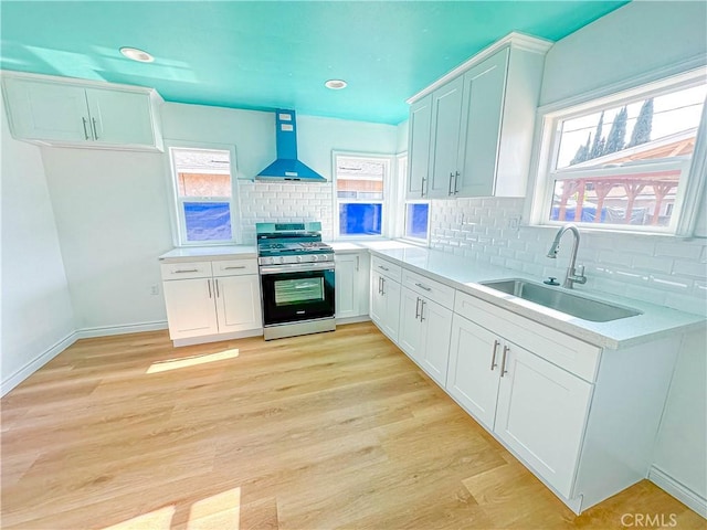 4709 Bresee Ave, Baldwin Park, CA 91706 - kitchen featuring gas range, wall chimney range hood, light countertops, a sink, and backsplash
