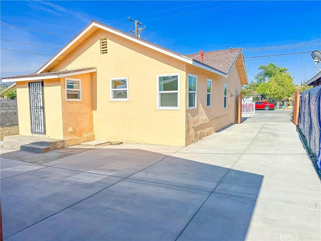 4709 Bresee Ave, Baldwin Park, CA 91706 - rear view of house with fence, a patio, stucco siding, and driveway