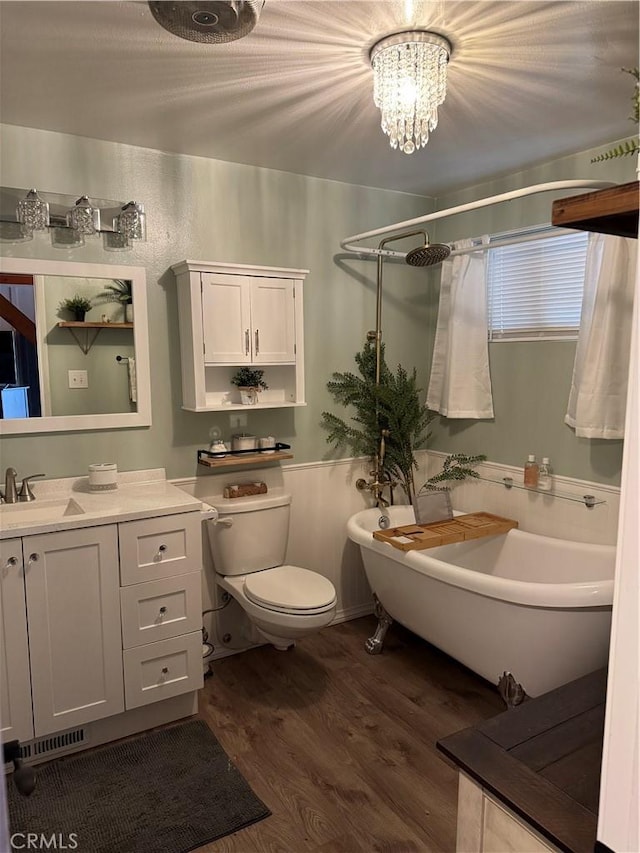 31347 Oakleaf Dr, Running Springs, CA 92382 - bathroom with walk in shower, a freestanding bath, vanity, toilet, and wood finished floors