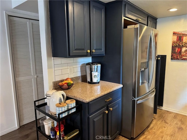 31347 Oakleaf Dr, Running Springs, CA 92382 - kitchen with stainless steel fridge, baseboards, decorative backsplash, and light wood finished floors