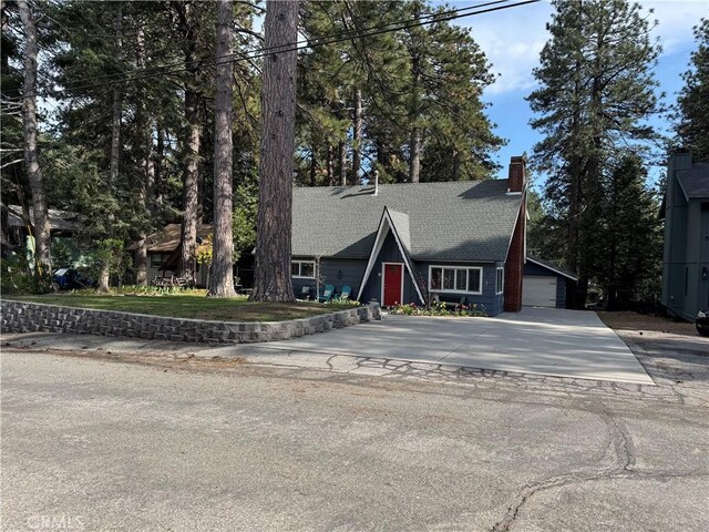 31347 Oakleaf Dr, Running Springs, CA 92382 - a-frame home with an attached garage, a shingled roof, a chimney, and concrete driveway