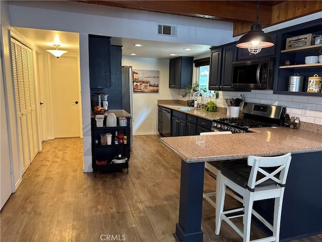 31347 Oakleaf Dr, Running Springs, CA 92382 - kitchen with a sink, stainless steel appliances, light wood-style flooring, and visible vents