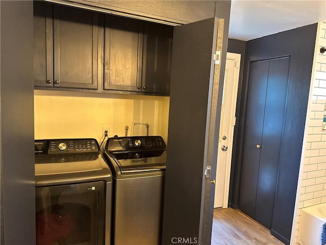 31347 Oakleaf Dr, Running Springs, CA 92382 - clothes washing area with cabinet space, washing machine and dryer, and light wood finished floors