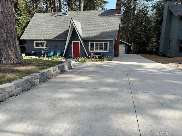 31347 Oakleaf Dr, Running Springs, CA 92382 - a-frame style home featuring a shingled roof, a chimney, and a garage