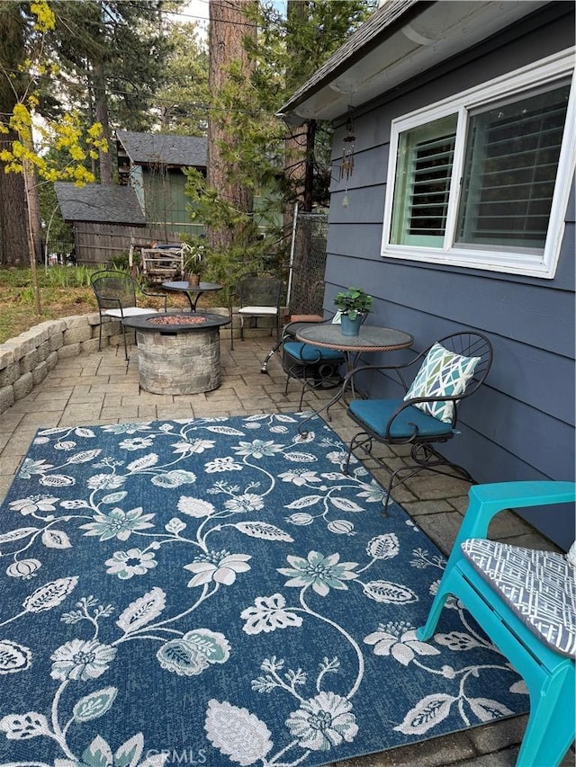 31347 Oakleaf Dr, Running Springs, CA 92382 - view of patio / terrace featuring an outdoor fire pit