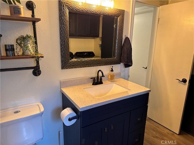 31347 Oakleaf Dr, Running Springs, CA 92382 - half bathroom with vanity, wood finished floors, and toilet