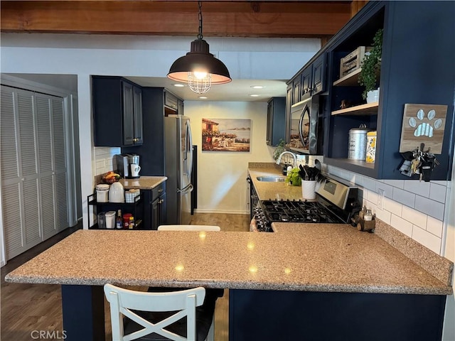 31347 Oakleaf Dr, Running Springs, CA 92382 - kitchen with a sink, wood finished floors, tasteful backsplash, and stainless steel appliances