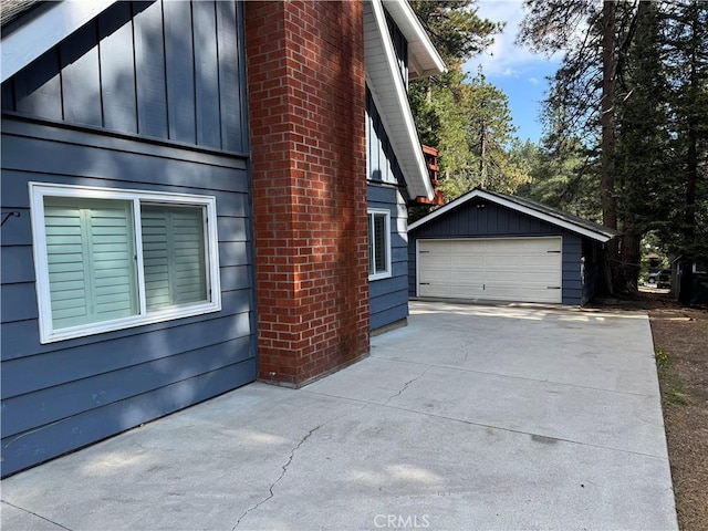 31347 Oakleaf Dr, Running Springs, CA 92382 - view of home's exterior with board and batten siding, an outbuilding, and a detached garage