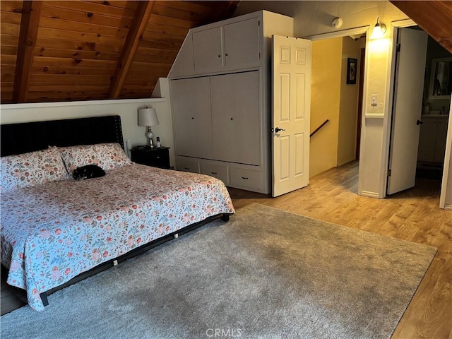 31347 Oakleaf Dr, Running Springs, CA 92382 - bedroom featuring light wood-style floors, wood ceiling, lofted ceiling with beams, and a closet