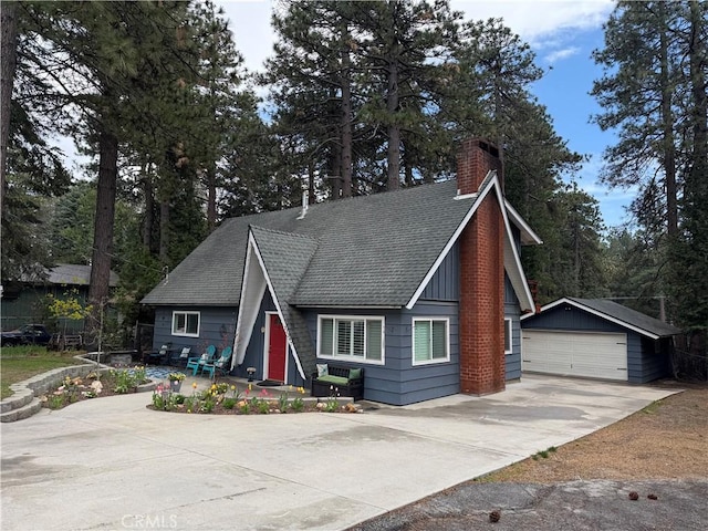 31347 Oakleaf Dr, Running Springs, CA 92382 - a-frame home with a detached garage, an outbuilding, a chimney, and a shingled roof