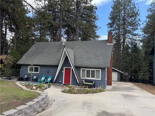 31347 Oakleaf Dr, Running Springs, CA 92382 - a-frame home with a garage, board and batten siding, a chimney, and a shingled roof