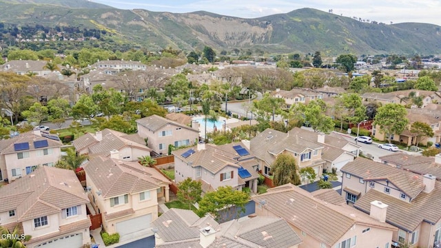drone / aerial view featuring a residential view and a mountain view