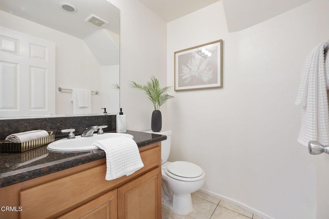 half bathroom with toilet, tile patterned floors, visible vents, baseboards, and vanity