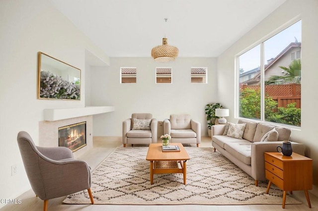 living room featuring a glass covered fireplace