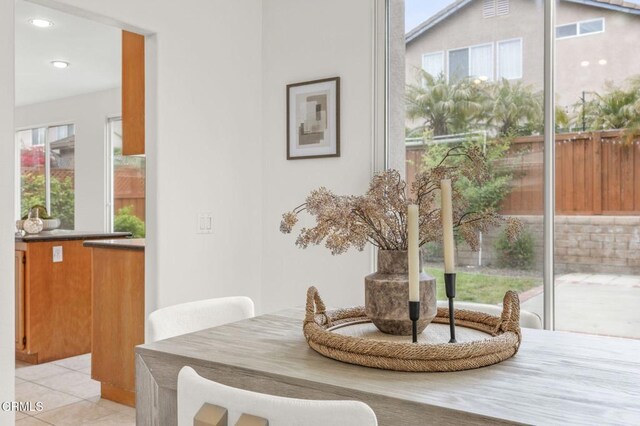 dining room with light tile patterned floors and recessed lighting