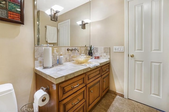 4433 E Justice Cir, Orange, CA 92869 - bathroom featuring toilet, baseboards, tile patterned flooring, vanity, and decorative backsplash