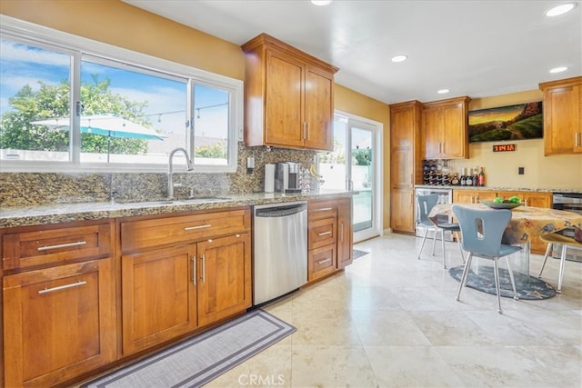 4433 E Justice Cir, Orange, CA 92869 - kitchen with backsplash, light stone countertops, a sink, and stainless steel dishwasher