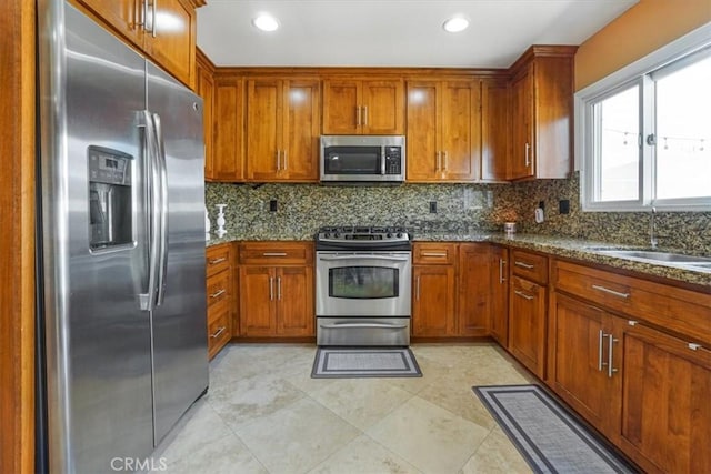 4433 E Justice Cir, Orange, CA 92869 - kitchen with backsplash, brown cabinets, appliances with stainless steel finishes, and a sink